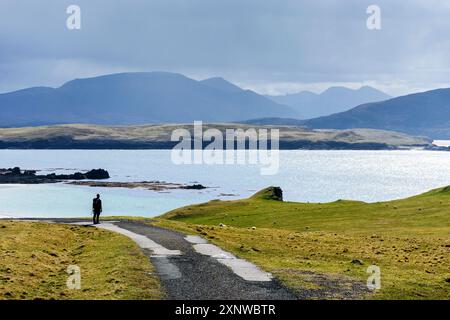 A walker looking across the Kyle of Durness from the track to Faraid Head, near Durness, Sutherland, Scotland, UK. Stock Photo