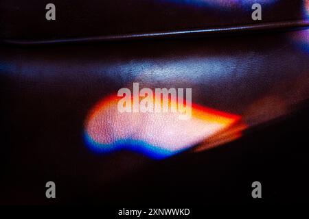 Colorful refracted sunlight through stained glass window illuminates expensive leather chair Stock Photo