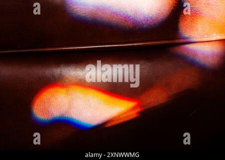 Colorful refracted sunlight through stained glass window illuminates expensive leather chair Stock Photo