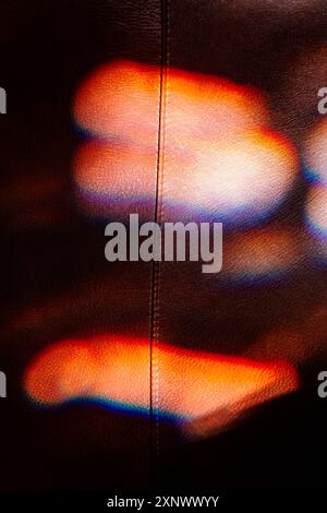 Colorful refracted sunlight through stained glass window illuminates expensive leather chair Stock Photo