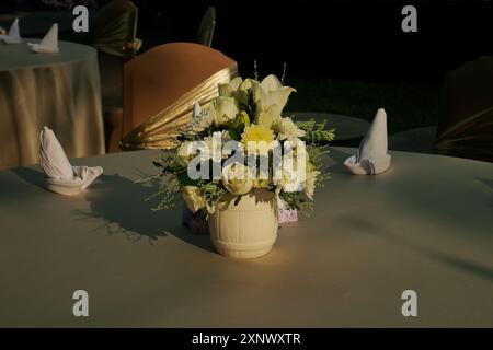 Flowers in a vase placed on a round table as a beautiful decoration Stock Photo