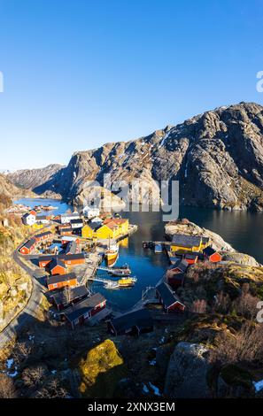 Nusfjord traditional fishing village with wooden rorbu on a sunny day in spring, Nusfjord, Lofoten Islands, Norway, Scandinavia, Europe Stock Photo