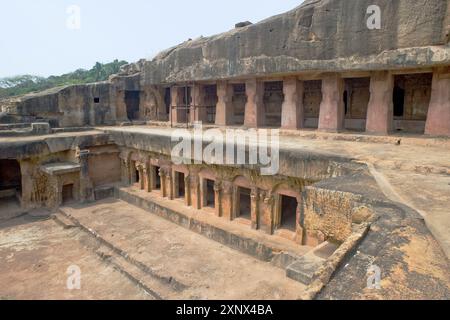 Monks' cells cut into the hillside rock among the Udayagiri and Khandagiri caves, religious retreats for Jain devotees, Bhubaneswar, Odisha, India Stock Photo