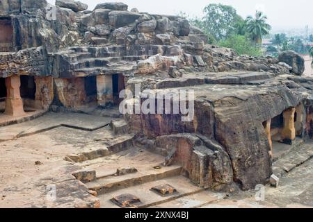 Monks' cells cut into the hillside rock among the Udayagiri and Khandagiri caves, religious retreats for Jain devotees, Bhubaneswar, Odisha, India Stock Photo