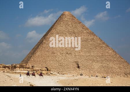 Tourists on Camels, Pyramid of Khafre (Chephren) in the background, Giza Pyramid Complex, UNESCO World Heritage Site, Giza, Egypt, North Africa Stock Photo