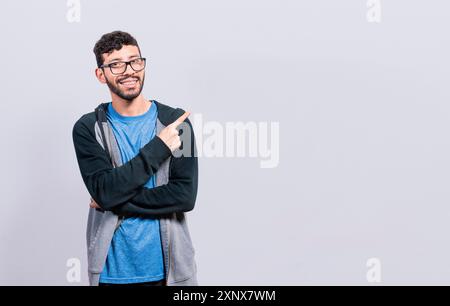 Smiling people pointing a banner to the side isolated. Happy young man pointing fingers to the sides isolated Stock Photo