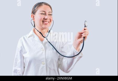 Smiling female doctor hand holding stethoscope isolated. Young female doctor holding stethoscope on white background Stock Photo