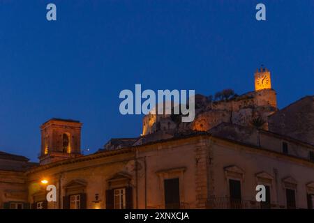 Townscape of the houses and castle Castello dei Conti in the city during blue hour at evening twilight, Modica, Sicily, Italy Stock Photo