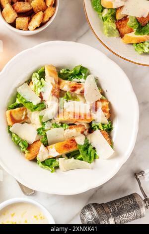 Caesar salad, shot from above on a white marble background Stock Photo