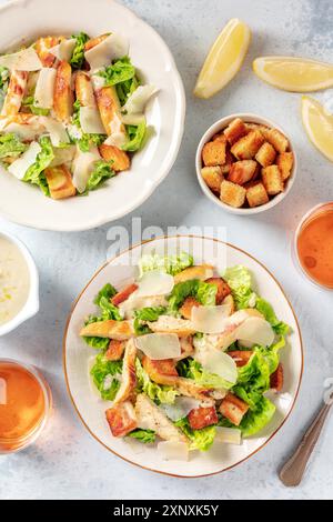 Chicken Caesar salad, shot from above with croutons and lemons Stock Photo