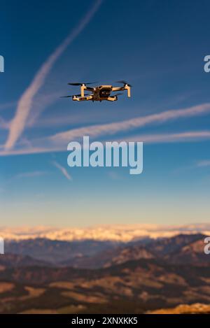 Graz, Austria, December 29 2019. DJI Mavic Mini drone flying in the countryside above Alp mountains. Drone flying Stock Photo