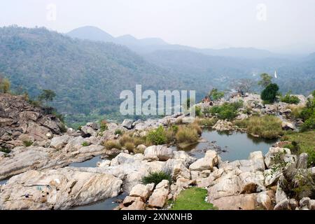 Local tribal women gather near the 322 feet Hundru waterfall to feast Shiva, the Supreme being in Hindu Shaivism, and beseech health and strength for Stock Photo