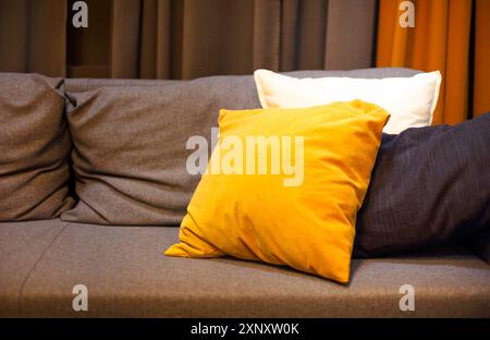 Living room interior with grey sofa and yellow pillows on it. Cozy background Stock Photo