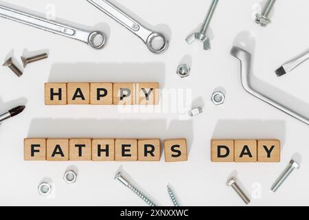 Happy Fathers Day blocks with tools on white background. Celebration event background Stock Photo