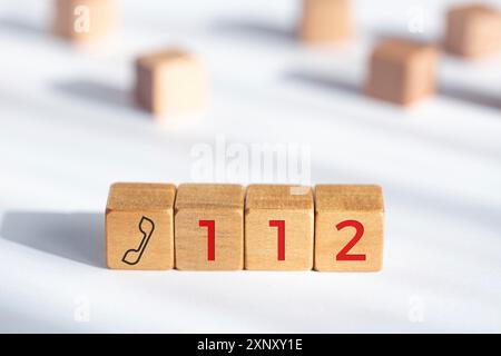 112 emergency concept. Wooden dices with phone icon and 112 text Stock ...