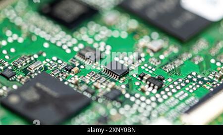 Green PCB (printed circuit board) close-up shot with a lot of electronic components Stock Photo
