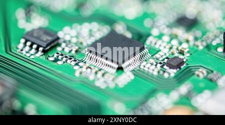 Green PCB (printed circuit board) close-up shot with a lot of electronic components Stock Photo