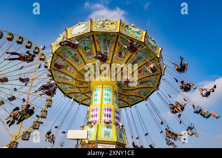 Herne, NRW, Germany. 02nd Aug, 2024. A traditional chairoplane carousel in the beautiful sunshine. Cranger Kirmes, Germany's 2nd biggest funfair (after Munich's Oktoberfest), opens today. The lively fair has a long tradition dating back to the 15th century where a horse market, and later medieval entertainers, wooed the crowds. Cranger Kirmes attracts around 4 million visitors each year at a dedicated site along the Rhine-Herne canal. Credit: Imageplotter/Alamy Live News Stock Photo