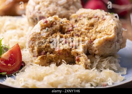 Bacon dumplings with sauerkraut on wood Stock Photo