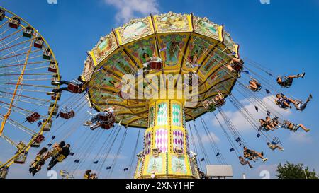 Herne, NRW, Germany. 02nd Aug, 2024. A traditional chairoplane carousel in the beautiful sunshine. Cranger Kirmes, Germany's 2nd biggest funfair (after Munich's Oktoberfest), opens today. The lively fair has a long tradition dating back to the 15th century where a horse market, and later medieval entertainers, wooed the crowds. Cranger Kirmes attracts around 4 million visitors each year at a dedicated site along the Rhine-Herne canal. Credit: Imageplotter/Alamy Live News Stock Photo