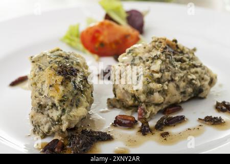 Italian strangolapreti dumplings on a plate Stock Photo