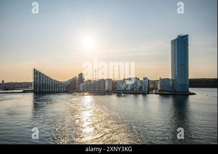 Modern futuristic Buildings and skyscraper of Aarhus Skyline Denmark with sea in front during sunset Stock Photo