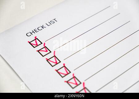 checklist with red check marks on paper Stock Photo