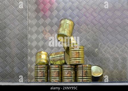 Falling tin can pyramid hit by a ball, throwing game at a carnival funfair or Christmas market, copy space, selected focus, motion blur Stock Photo