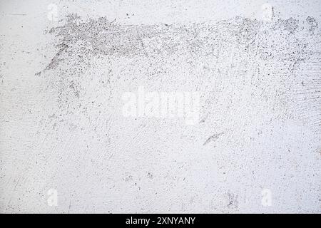 Plastered wall surface with rubbed off white paint, light gray background texture for urban themes or architecture, full frame, copy space Stock Photo