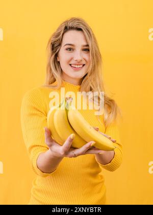 Front view woman holding bananas Stock Photo