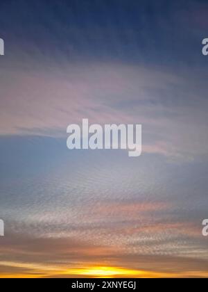 Beautiful winter sunset sky background. Colorful dusk clouds Stock Photo