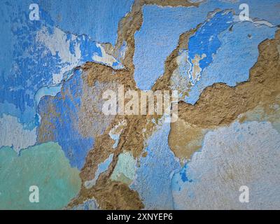 Old peeling wall with different layers of construction materials. Weathered lime facade with clay and dung plaster. Abstract texture of a building Stock Photo