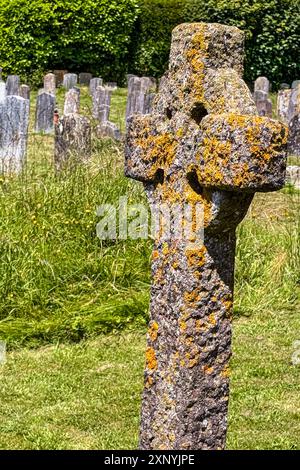 Ancient stone church stands weathered against a blue sky in Armenia’s ...