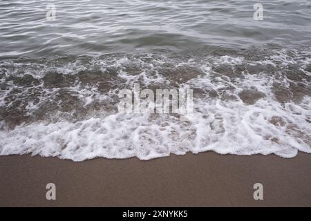 Soft wave of the sea on the sandy beach Stock Photo