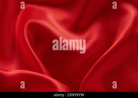 Red satin background with waves. Tissue, textile, cloth, fabric, material, texture Stock Photo