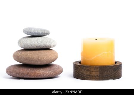 Spa stones with candle isolated on white background. Zen concept Stock Photo