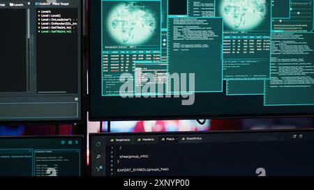 Close up of code running on computer displays in empty apartment used by hacker stealing secrets. Illegal scripts on PC screens used by spy infiltrating governments, handheld camera shot Stock Photo