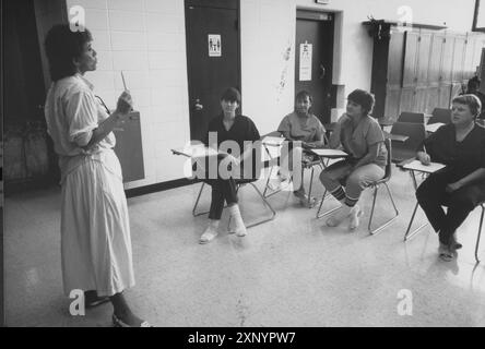 Austin, Texas USA  1992: Female inmates listen to instructor during remedial writing and reading class at the Travis County Jail.  No model releases available.  ©Bob Daemmrich Stock Photo