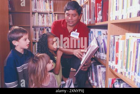 Austin, Texas USA:  Male librarian with first graders at Walnut Creek Elementary School. ©Bob Daemmrich Stock Photo