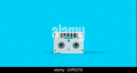 Front view of old white mini DV cassette on a blue surface against blue background Stock Photo