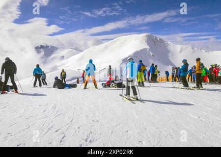 Saalbach, Austria, March 6, 2020: Skiers and snowboarders ready for skiing from top ski lift station Stock Photo