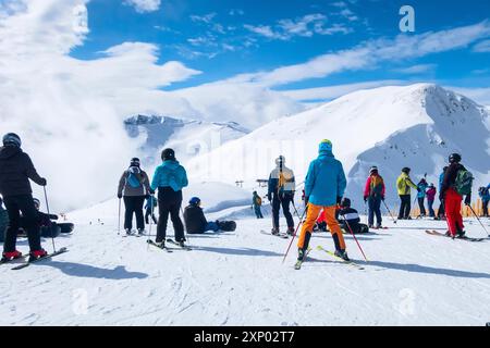 Saalbach, Austria, March 6, 2020: Skiers and snowboarders ready for skiing from top ski lift station Stock Photo