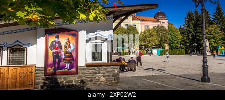 Razlog, Bulgaria, October 20, 2020: Downtown street square panoramic view with autumn trees and people panorama Stock Photo