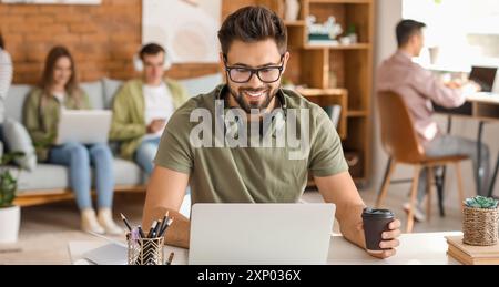 Male student with laptop in university Stock Photo