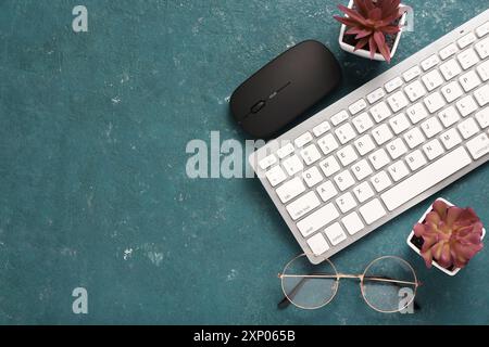 Modern computer keyboard, mouse, glasses and cup of coffee on blue grunge background Stock Photo