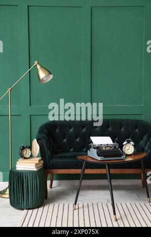 Interior of stylish living room with sofa and vintage typewriter on table Stock Photo