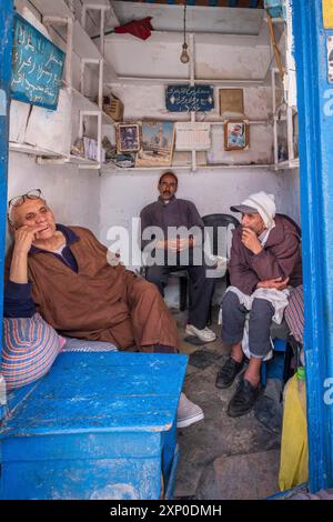 Men relaxing, Surroundings of the Ben Youssef Mosque, Essaouira, morocco Stock Photo