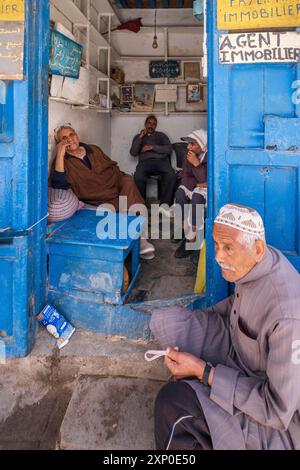 Men relaxing, Surroundings of the Ben Youssef Mosque, Essaouira, morocco Stock Photo