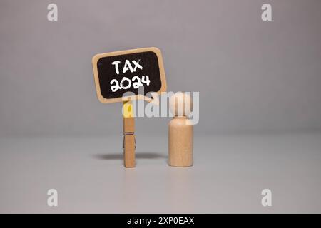 tax- 2024. notepad with text near calculator. Budget planning concept Stock Photo