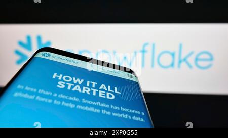 Stuttgart, Germany, 03-05-2022: Smartphone with website of American software company Snowflake Inc. on screen in front of business logo. Focus on Stock Photo